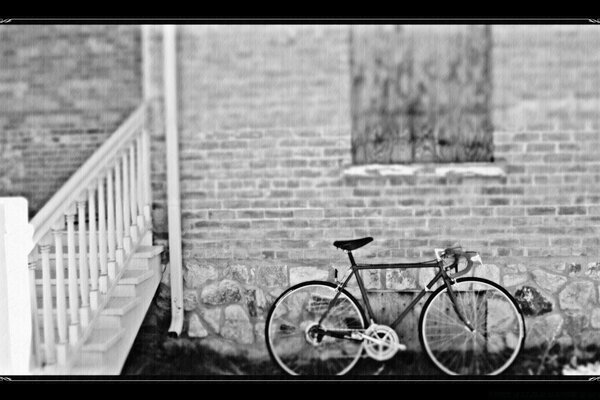 Vintage bike at the black and white stone wall