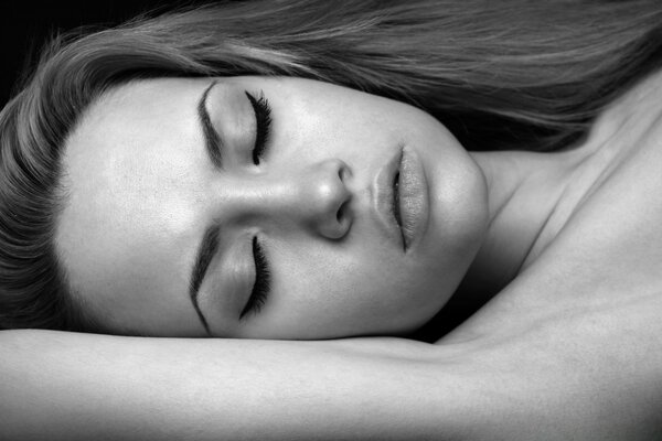 Black and white portrait of a sleeping woman