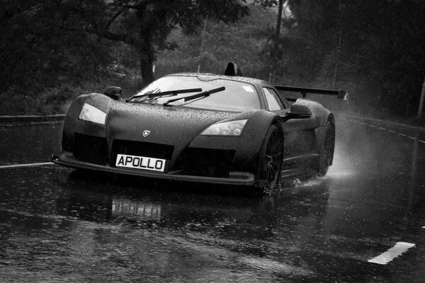 A sports car is flying on a wet road in the rain