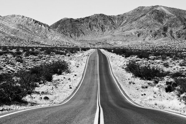 A deserted highway on the background of a mountain range