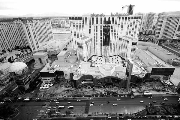 The architecture of the city and passing cars in black and white