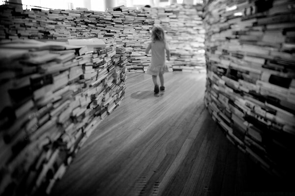 A girl walks through a black and white maze