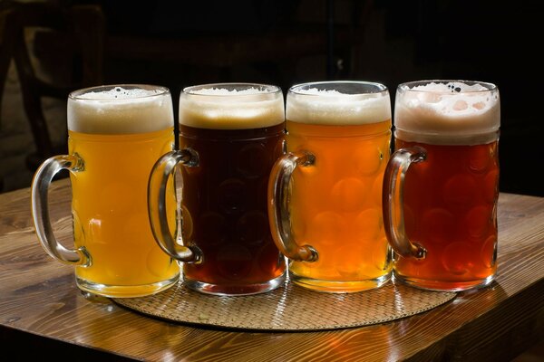 Four beer glasses with different types of beer