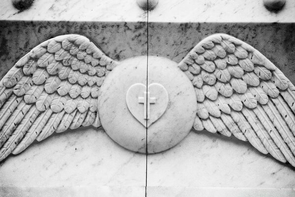 Cross and heart on the emblem with wings