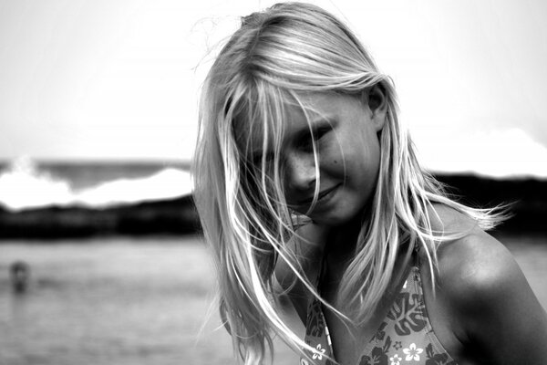 A girl with blonde hair on the beach