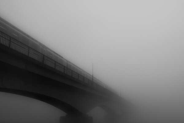 The train on the bridge, leaving in the fog