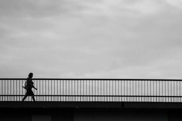 Black and white bridge and silhouette of a woman