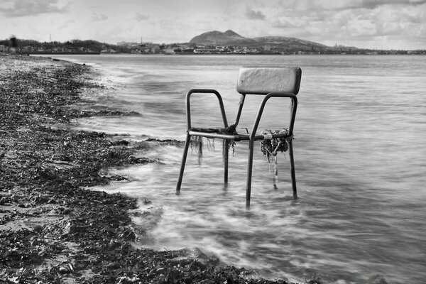 Chair on the background of the sea and the beach