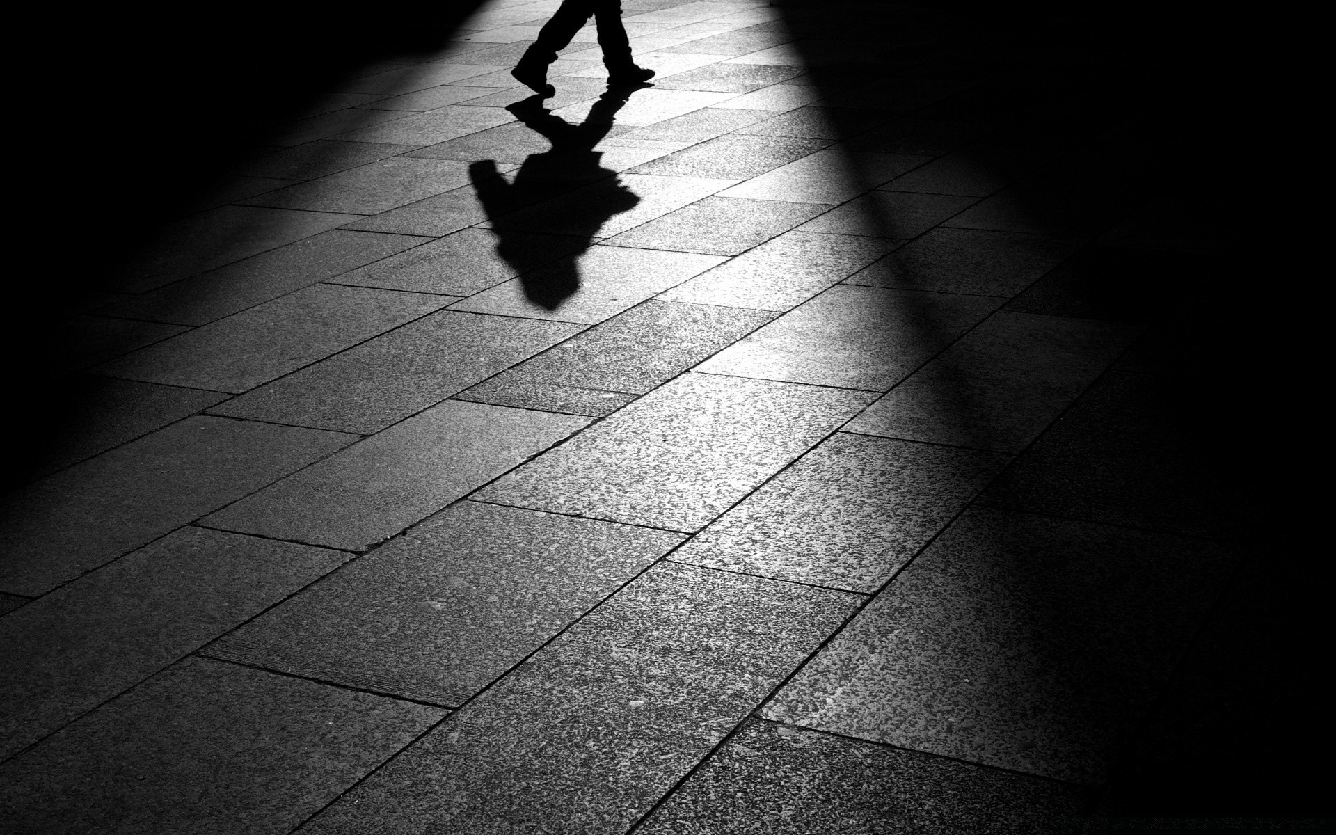 black and white monochrome street shadow pavement dark floor city man blur motion one adult square wall urban abstract