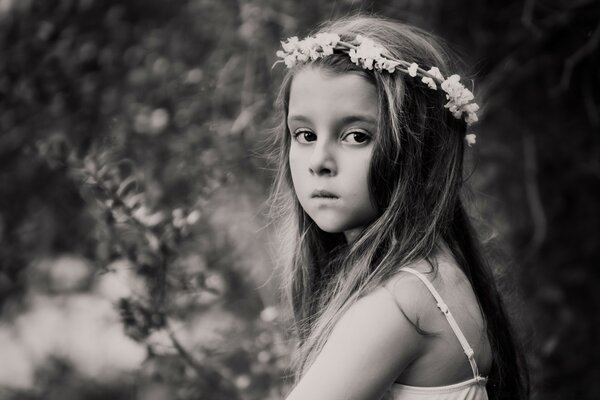 Portrait of a girl with a wreath in the forest