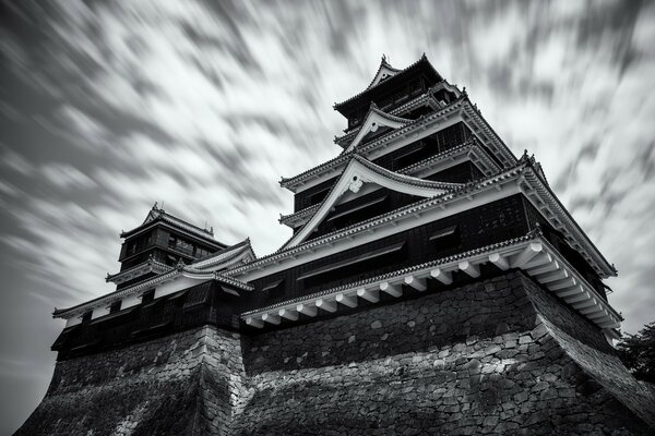 A black and white building against a blurry sky