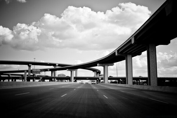 A road with a bridge in black and white