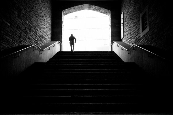 Image of a man walking away down the stairs