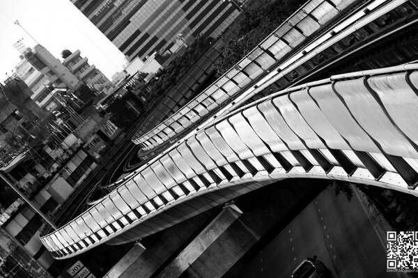 Monochrome bridge goes into the distance of the city