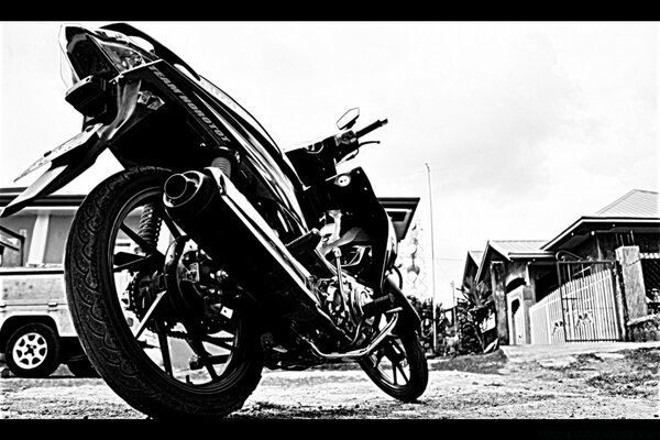 Black and white photo of a motorcycle taken from below