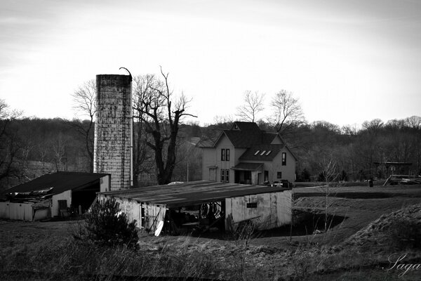 Old photo of a house with a barn