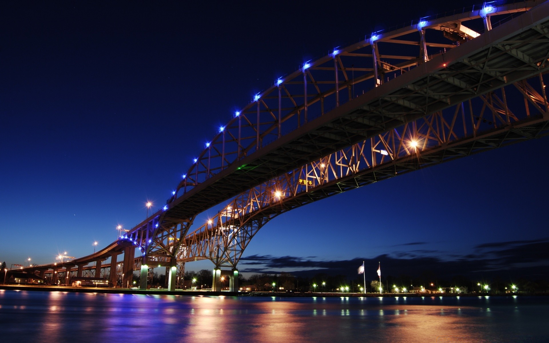 other city bridge water dusk river travel architecture evening connection sky sunset city illuminated reflection suspension bridge transportation system traffic