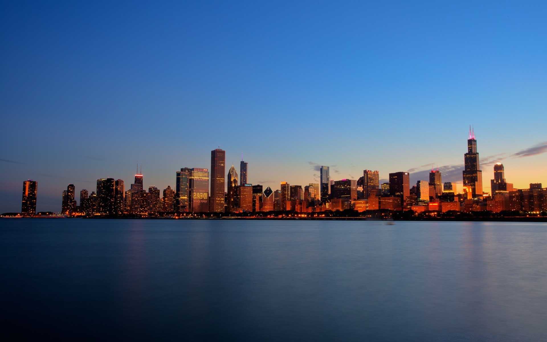 other city architecture downtown city skyline dusk sunset cityscape water skyscraper river sky building business office reflection travel evening waterfront