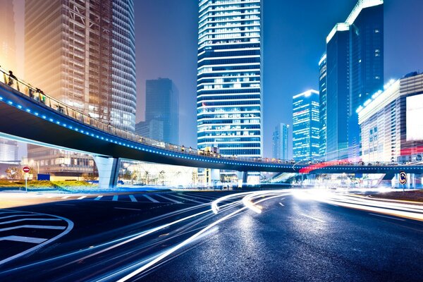 A city with skyscrapers with a road for cars