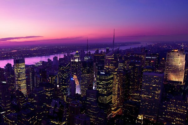 City skyscrapers against a purple sunset