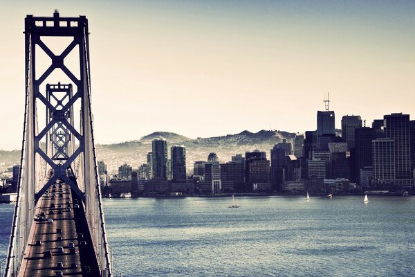 Bridge over the river on the background of the city