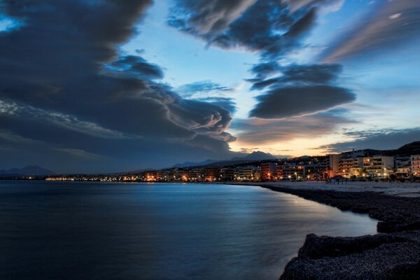 Sea beach with houses at sunset