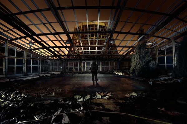 A man is barely visible in an abandoned room