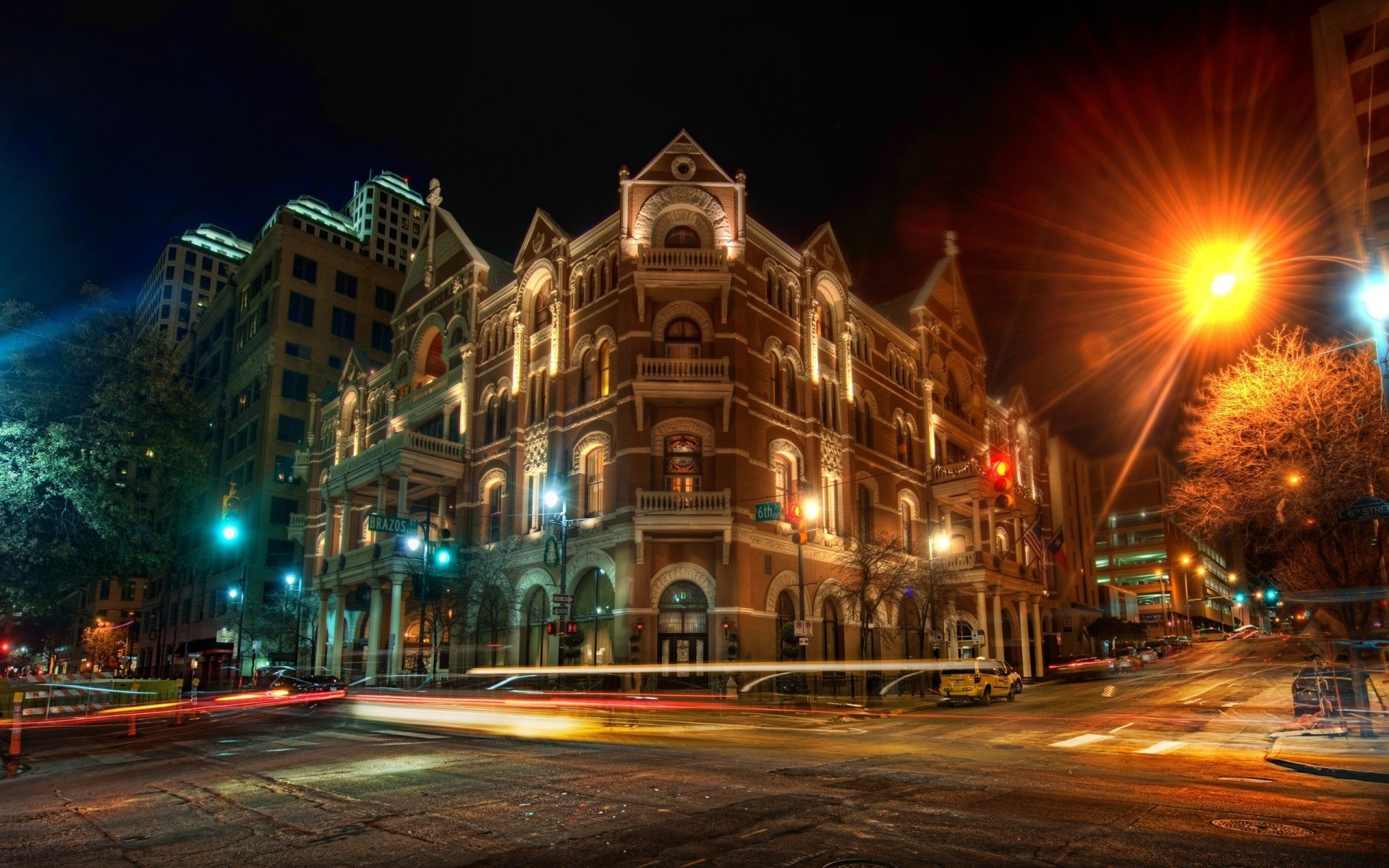 other city street city road evening travel dusk urban building illuminated light car traffic architecture scene transportation system downtown bus blur