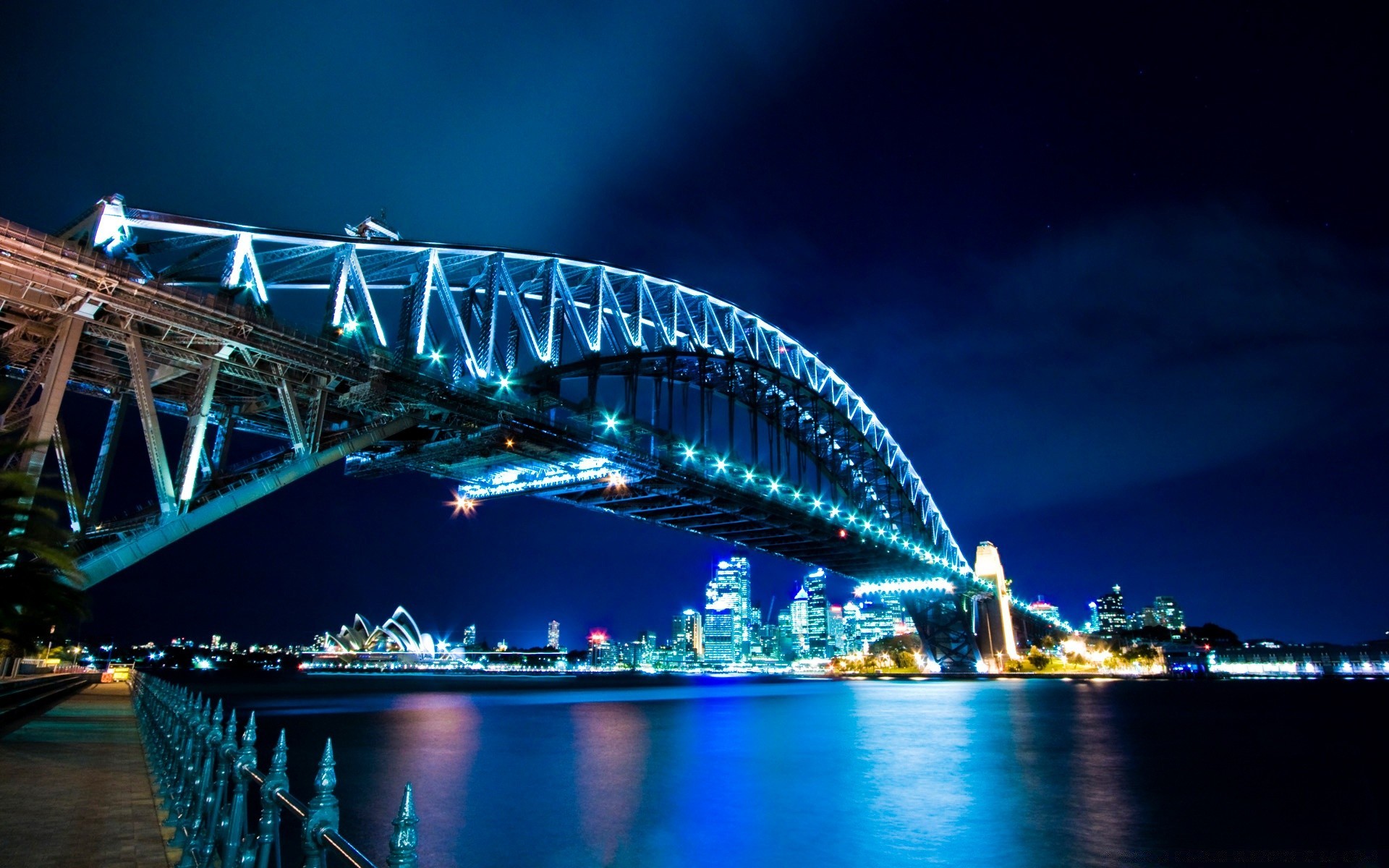 other city bridge water travel transportation system city river architecture sky evening dusk building urban opera connection suspension bridge vehicle cityscape light sunset