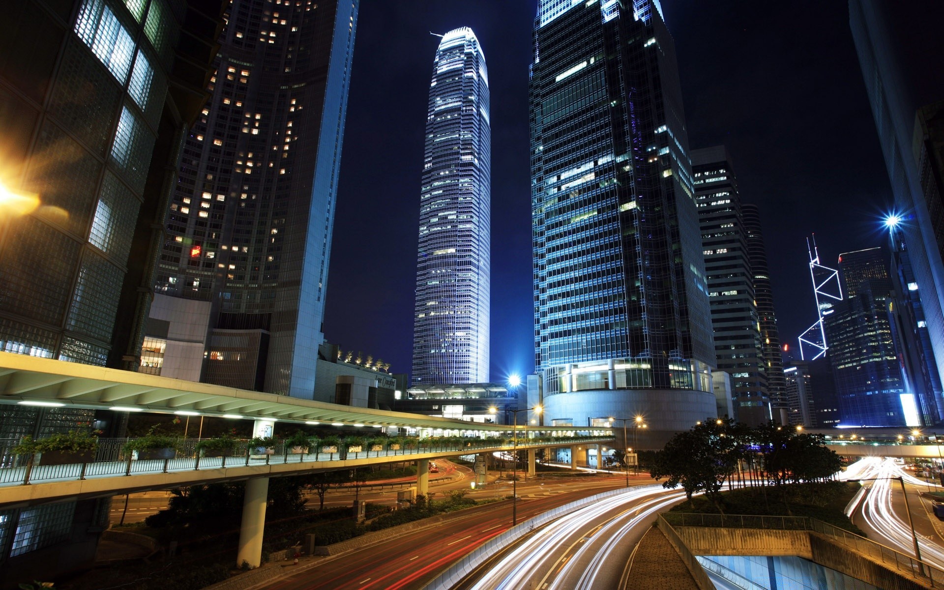 other city city downtown dusk skyscraper road traffic architecture building transportation system blur evening street bridge travel urban highway car bus fast light