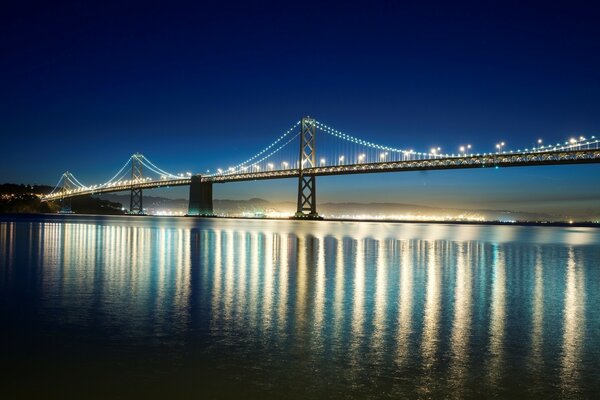 Night bridge illumination reflection in the water