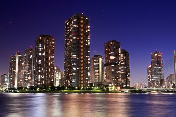 A bridge across the river and bright skyscrapers