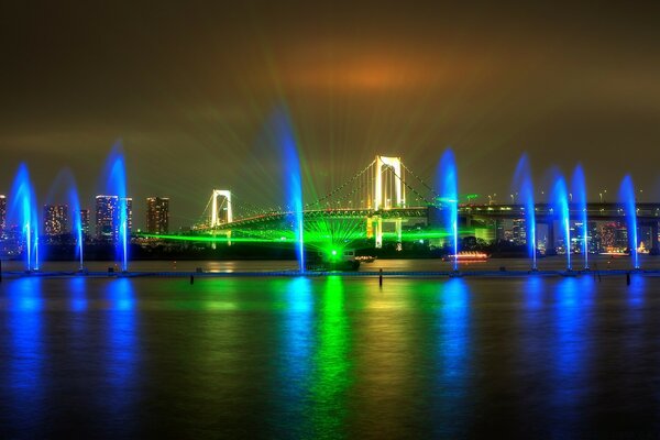 Colored fountains on the river bank