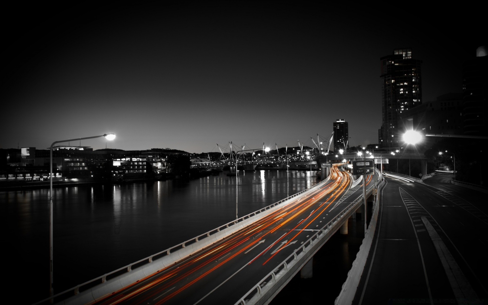 other city bridge city evening dusk travel transportation system water river street reflection architecture road downtown urban light traffic building highway skyscraper