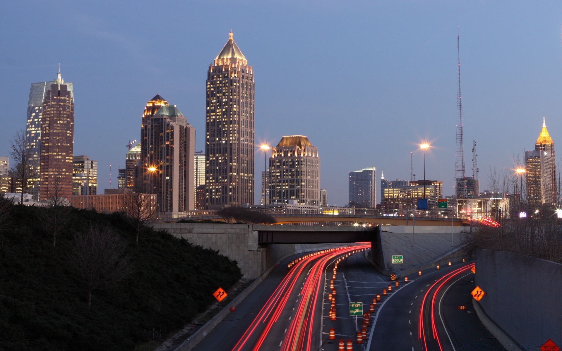 other city city traffic skyscraper travel highway road downtown transportation system dusk architecture street cityscape evening building skyline bridge urban business car