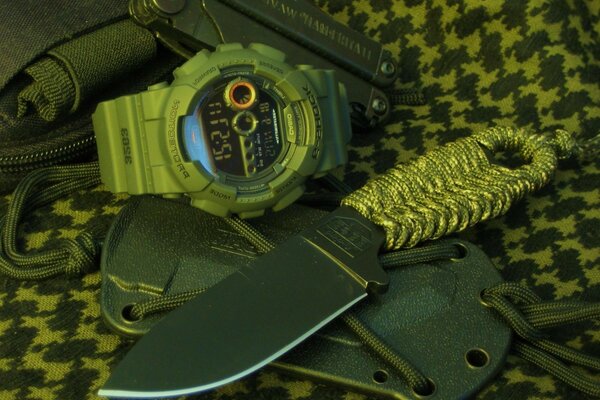 Knife, watch, multitool in military style