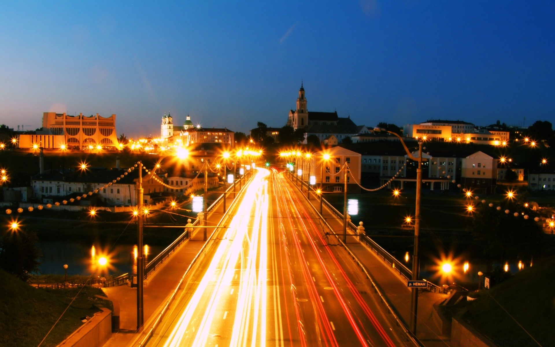 other city traffic road street car city highway transportation system dusk evening travel bridge downtown blur light bus urban fast expressway illuminated building