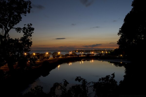 Sunset on the background of a lighted bridge