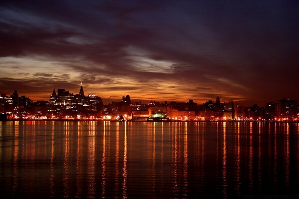 Bela cidade noturna. Reflexo na água