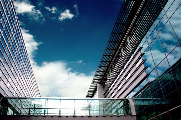 The sky reflecting in the windows of modern buildings