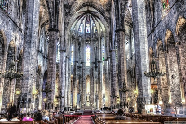 Grey cathedral from inside with people