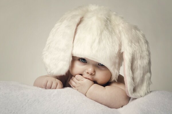 A newborn baby in a bunny hat