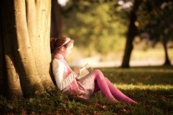 Alice is reading a book under a tree