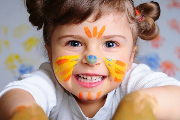 A child with a painted face with paints