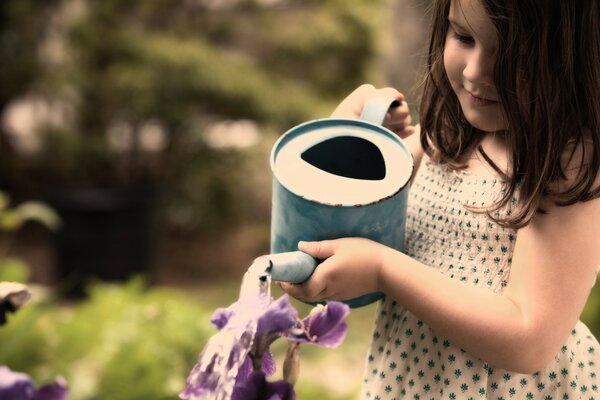 Beautiful girl watering flowers