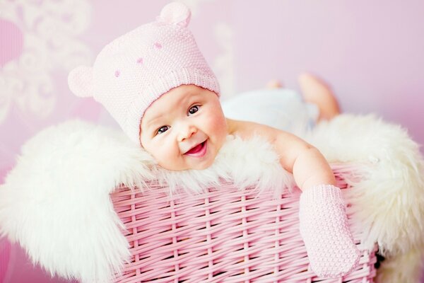 A small child in a pink basket