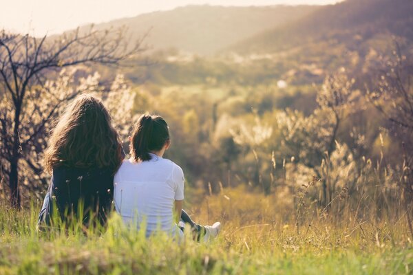 A couple of girls are looking at a beautiful landscape