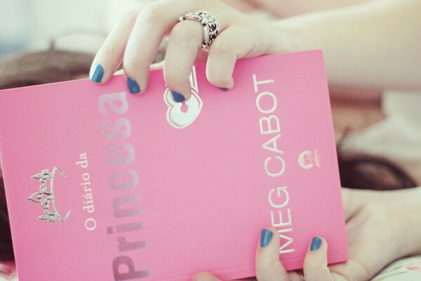 Young girl with pink book