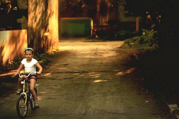 Child on a bicycle, street and city