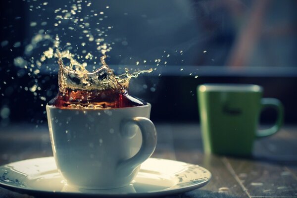 A cup of coffee with splashes